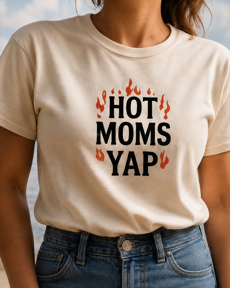 Woman at the lake wearing a cream YapThreads Hot Moms Yap tee with flame lettering